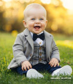 Elegancki szary płaszczyk do chrztu dla chłopca o kroju marynarki z guzikami.